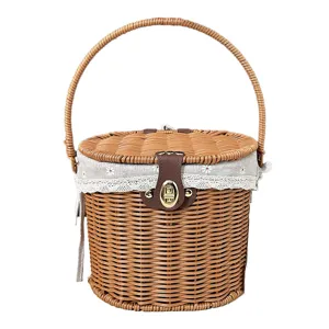Wicker picnic basket with lid fabric liner and handle for outdoor camping and home storage use.