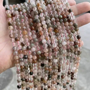 Detailed view of 6mm natural ice-clear colorful rutilated quartz crystal beads