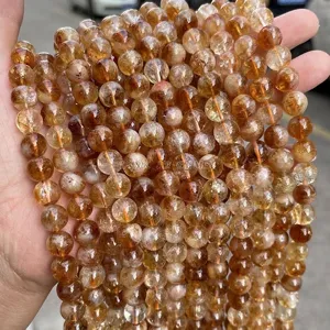 Vista dettagliata di perle rotonde in citrina gialla naturale da 8mm con inclusioni