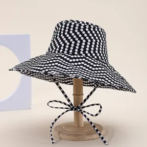 Black and white polka dot wide brim bucket hat detail, women summer beach sun protection hat.