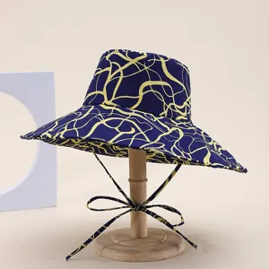 Stylish women's wide brim bucket hat with blue and yellow abstract print for summer outdoor sun.