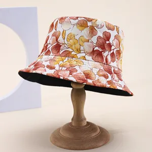 Detailed view of a double-sided bucket hat with vibrant autumn leaf print pattern