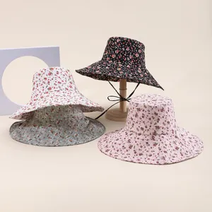 Close-up detail of floral bucket hat, foldable soft brim design for summer beach sun protection.