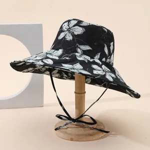 Detail view of a wide-brim floral bucket hat with ties, stylish sun protection sunhat for women.
