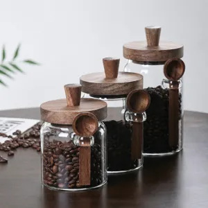 High borosilicate glass coffee bean storage jar set with wooden lid and spoon for kitchen.