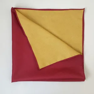 Dettaglio ravvicinato di pregiato tessuto decorativo bicolore rosso e oro per regali.