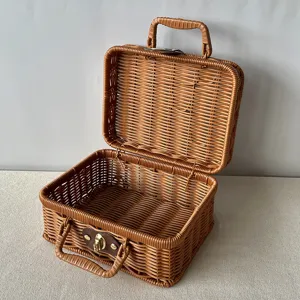 Detailed view of an open hand-woven brown rattan gift basket with handle and clasp
