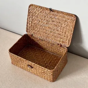 Detail view of a handmade woven seagrass storage box with wooden button closure.