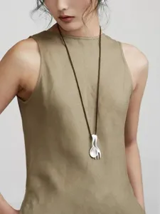 Model wearing a creative silver fork and spoon pendant necklace on a long brown cord