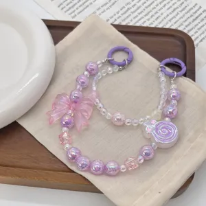 Detailed view of sweet dopamine style beaded phone strap with bow and lollipop charms