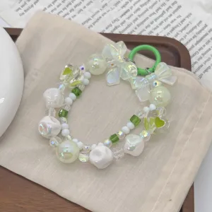Macro view of hand-painted beads and butterfly charms for sweet dopamine accessory style.