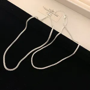 Detailed view of a sparkling silver textured gypsophila chain necklace on black velvet
