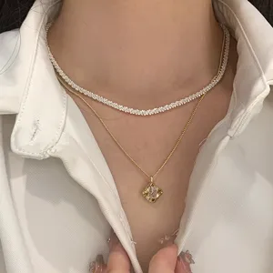 Close-up detail of layered sparkling starry sky necklace and gold gemstone pendant set