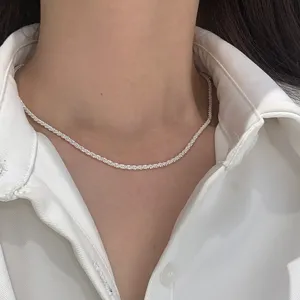 Close-up macro view of a minimalist sparkling starry silver necklace for women worn on neck