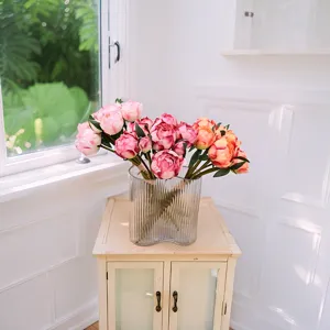 Elegant artificial peony flower bouquet with 9 pink and orange buds in a ripple glass vase