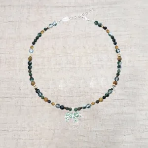 Gedetailleerd macrozicht op vintage zebra hanger ketting met groene kralen en verlenging