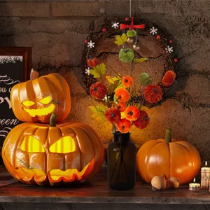 Detail shot of harvest velvet pumpkins on branches and glowing jack-o'-lanterns decor