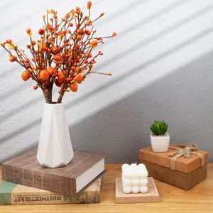 Autumn harvest festival artificial pumpkin berry branches in a white geometric vase