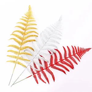 Detailed close-up view of festive glitter hollow Persian leaves in gold, silver, and red colors