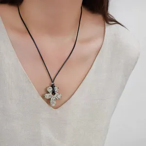 Close-up of minimalist flower pendant necklace on a model's neck for elegant look