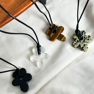 Detail of flower-shaped stone pendants in Tiger's Eye and Jasper with black cords