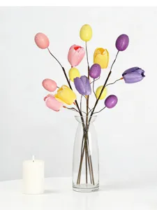 Makro-Detail des farbenfrohen Oster-Tulpen- und Eier-Blumenarrangements in einer Glasvase