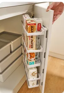 Detail view of plastic pegboard organizer mounted inside a kitchen cabinet door