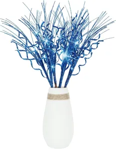 Detailed macro shot of shimmering blue glitter curly Christmas tree filler stems in white vase
