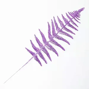Detailed macro view of a purple glitter artificial Persian leaf for Christmas decor