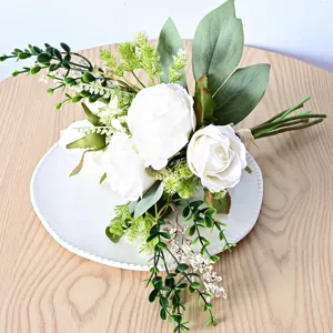 Vue détaillée du bouquet de mariage de roses blanches artificielles avec eucalyptus.