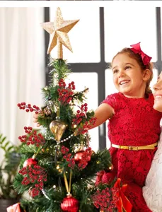 Decorative artificial red berries displayed on a festive Christmas tree.