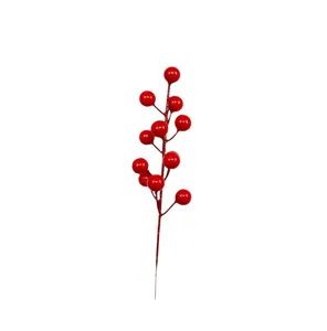 Macro detail of artificial red holly berries stem for festive Christmas home decoration