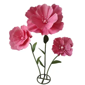 Gros plan sur les grandes fleurs de coquelicot artificielles roses avec des tiges.