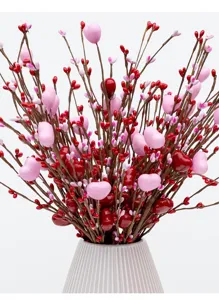 Close-up detail of artificial red and pink heart-shaped berries for romantic home decor.