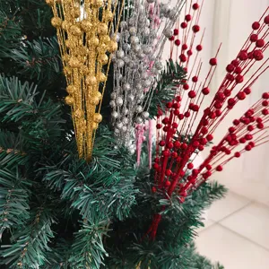 Close-up of glittery gold, silver, and red foam berry stems on a Christmas tree