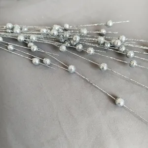 Detailed macro view showing the silver glitter texture on Christmas foam berry stems