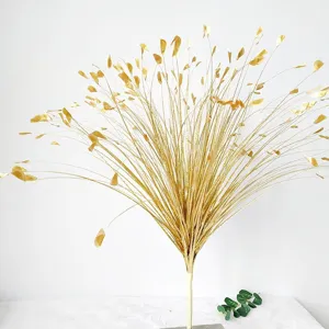Close-up of gold glitter artificial peacock grass for elegant wedding floral decorations