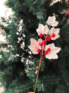 Detail showing silver maple leaves and red berries on a Christmas decorative branch