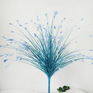 Detailed macro view of blue artificial glitter peacock grass onion leaf for wedding decoration.