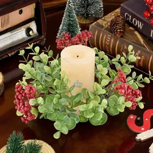 Close-up of eucalyptus Christmas candle ring with red berries on a vintage table setting