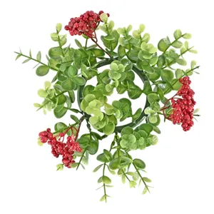 Decorative eucalyptus and red berry Christmas candle ring for festive dining table layout