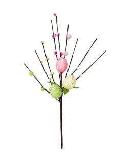 Macro detail view of artificial Easter egg branch with pink hearts and speckled eggs.