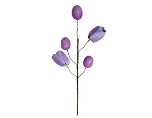 Nahaufnahme eines lila Osterzweigs mit zarten Tulpen und gesprenkelten Kunststoffeiern