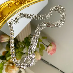 Detailed close-up view of a retro silver Roman chain necklace with dual link styles