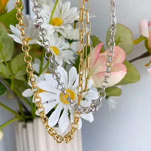 Close-up detail showing the metallic texture of gold and silver layered chain necklaces