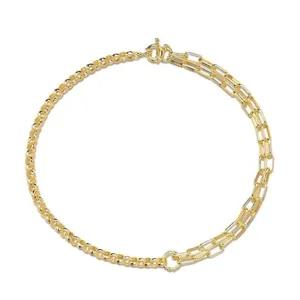 Detail of gold asymmetric chain necklace featuring round and paperclip link designs