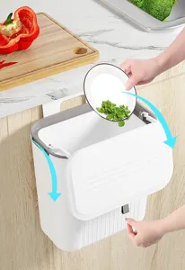 Wall-mounted kitchen trash can with sliding lid shown collecting food scraps from a plate