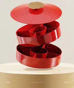 Exploded view of a red multi-layer partitioned snack box with gold accents