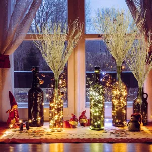 Christmas gold glitter branch detail in glass bottle fairy light decor for holiday home setup