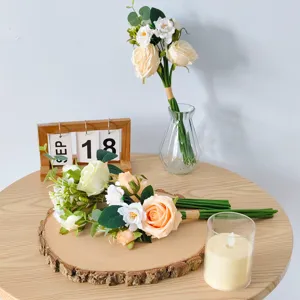 Artificial rose and camellia bouquet on a wooden slab for home decor